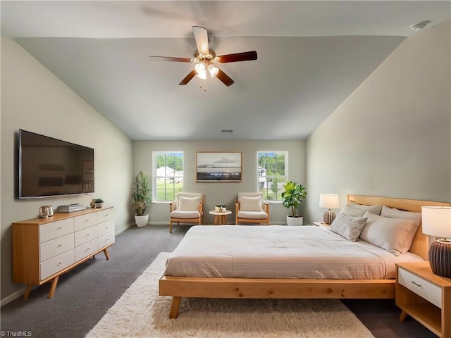 bedroom with visible vents, baseboards, carpet floors, vaulted ceiling, and a ceiling fan