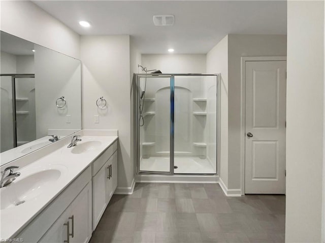 bathroom with baseboards, a stall shower, and a sink