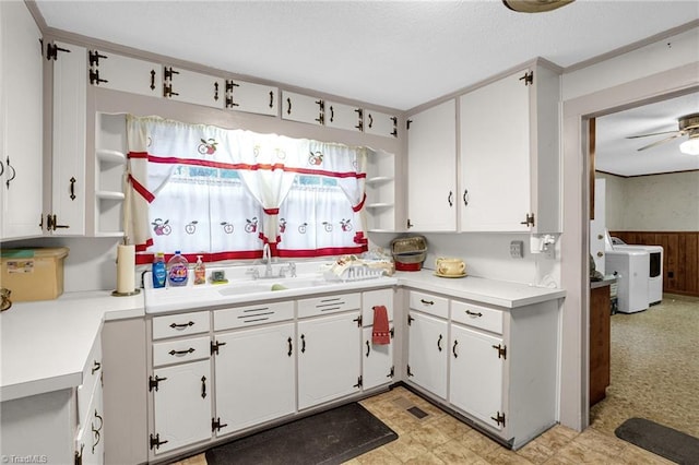 kitchen with white cabinetry, ceiling fan, washer / clothes dryer, and sink