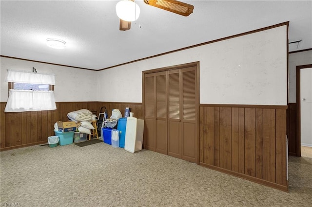 unfurnished bedroom featuring crown molding, ceiling fan, and a closet