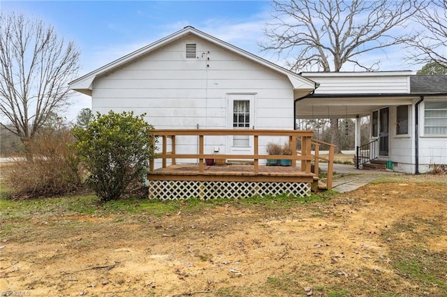 back of house featuring a deck