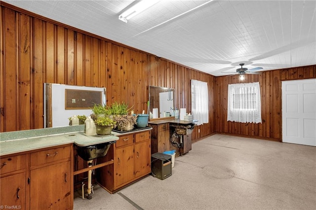 miscellaneous room with ceiling fan and wood walls