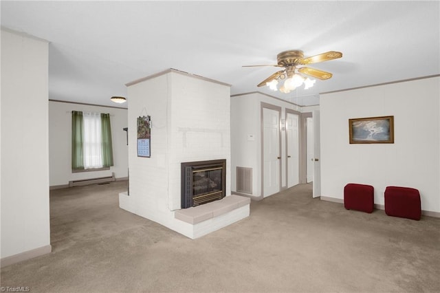 unfurnished living room featuring ornamental molding, a brick fireplace, light carpet, and a baseboard heating unit