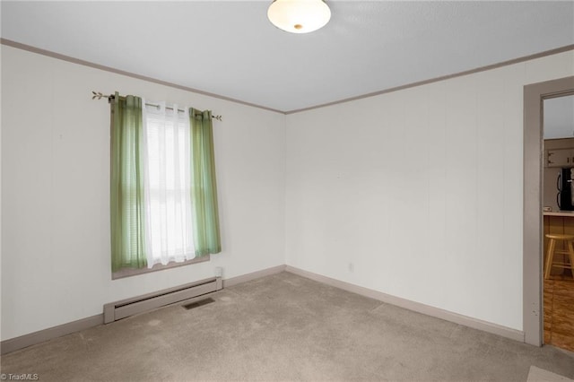 spare room featuring baseboard heating, crown molding, and light carpet