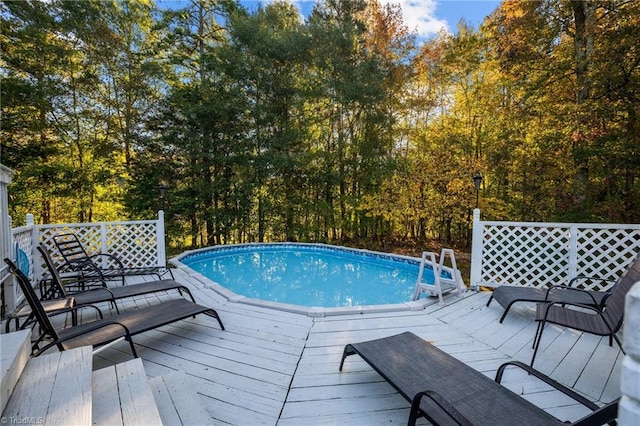 view of swimming pool with a wooden deck