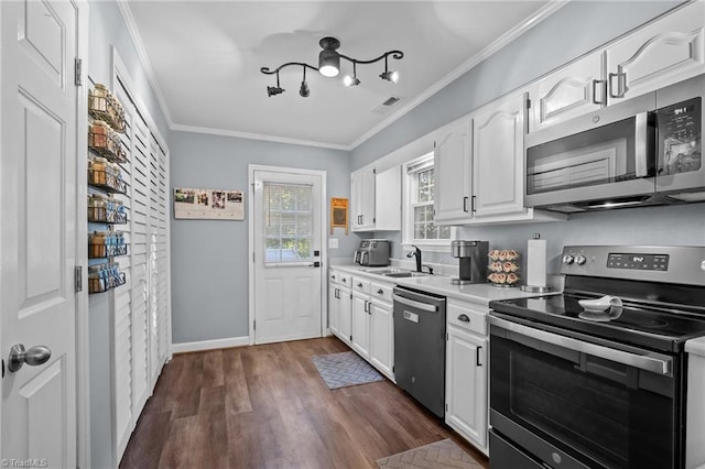 kitchen featuring appliances with stainless steel finishes, crown molding, dark hardwood / wood-style floors, and white cabinets