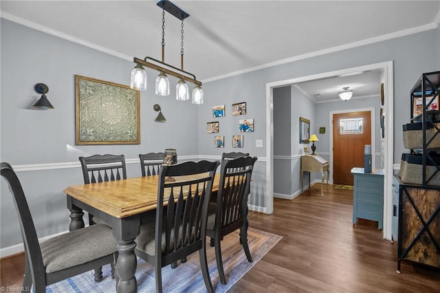 dining room featuring dark wood-type flooring and crown molding