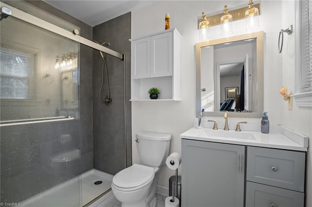 bathroom with walk in shower, vanity, and toilet