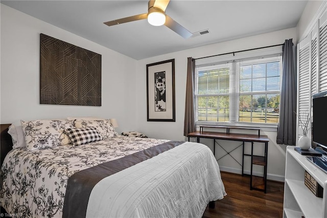 bedroom with dark hardwood / wood-style flooring, ceiling fan, and a closet