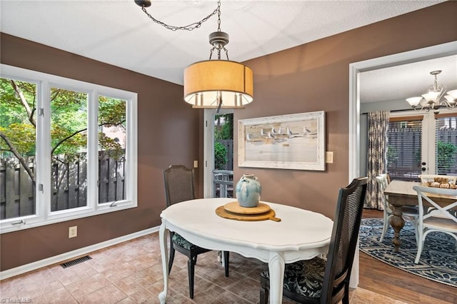 6404 Muirfield Dr, Greensboro, NC 27410 - dining space with a chandelier and baseboards