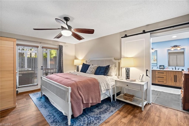 6404 Muirfield Dr, Greensboro, NC 27410 - bedroom featuring access to outside, wood finished floors, a textured ceiling, ensuite bathroom, and ceiling fan