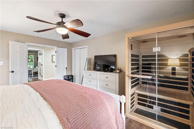 6404 Muirfield Dr, Greensboro, NC 27410 - bedroom featuring multiple closets, a ceiling fan, wood finished floors, and a textured ceiling