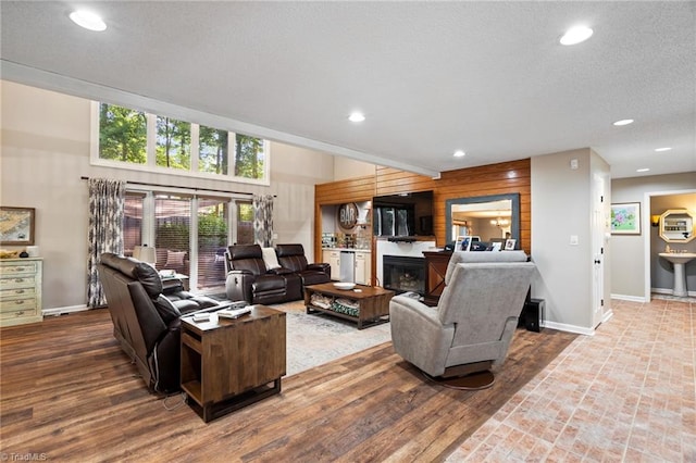 6404 Muirfield Dr, Greensboro, NC 27410 - living area featuring baseboards, recessed lighting, a glass covered fireplace, and wood finished floors