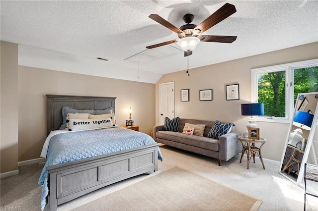 6404 Muirfield Dr, Greensboro, NC 27410 - carpeted bedroom with attic access, lofted ceiling, baseboards, ceiling fan, and a textured ceiling