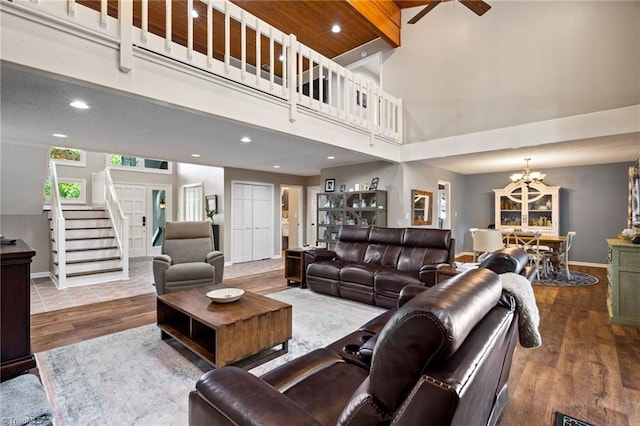 6404 Muirfield Dr, Greensboro, NC 27410 - living area featuring a chandelier, a towering ceiling, wood finished floors, baseboards, and ceiling fan