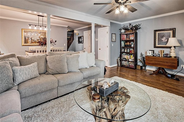 living room featuring ceiling fan, crown molding, and dark hardwood / wood-style flooring