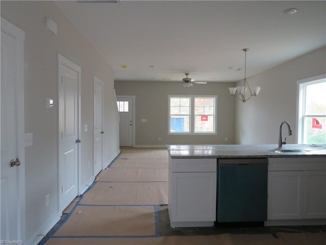 kitchen with black dishwasher, plenty of natural light, sink, and decorative light fixtures