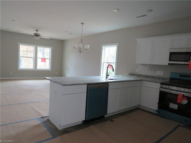 kitchen with white cabinets, a wealth of natural light, stainless steel appliances, and sink