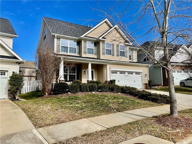 view of front of property featuring a garage and a front lawn