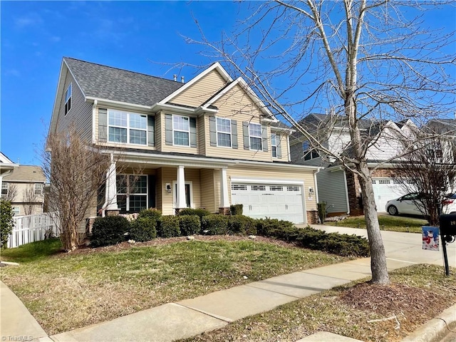 view of front of property with a garage and a front lawn