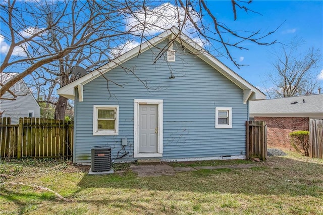 back of house featuring a yard, fence, cooling unit, and crawl space