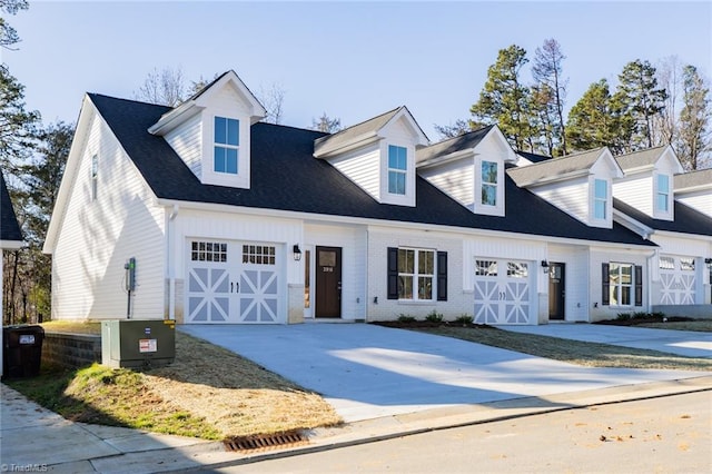 new england style home featuring a garage and central AC