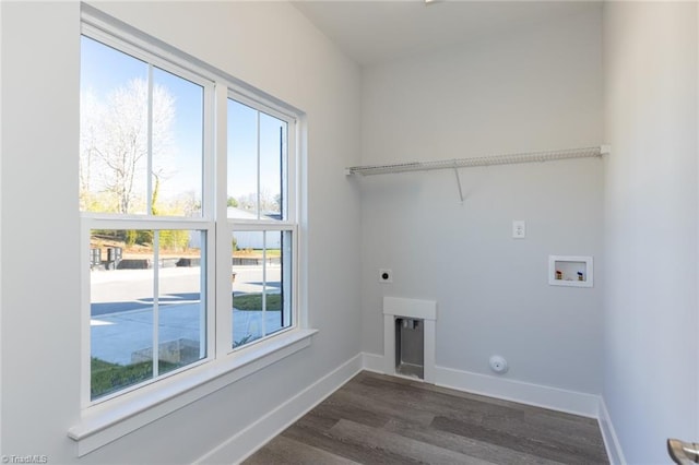 laundry area with laundry area, hookup for a washing machine, baseboards, and hookup for an electric dryer