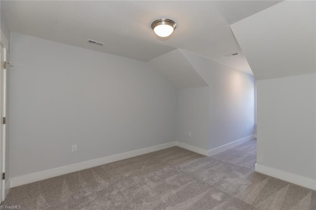 bonus room with vaulted ceiling, carpet floors, visible vents, and baseboards