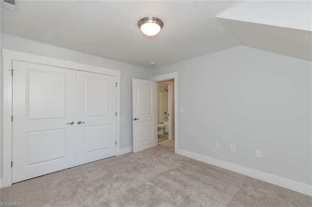 unfurnished bedroom with a closet, carpet, visible vents, and baseboards