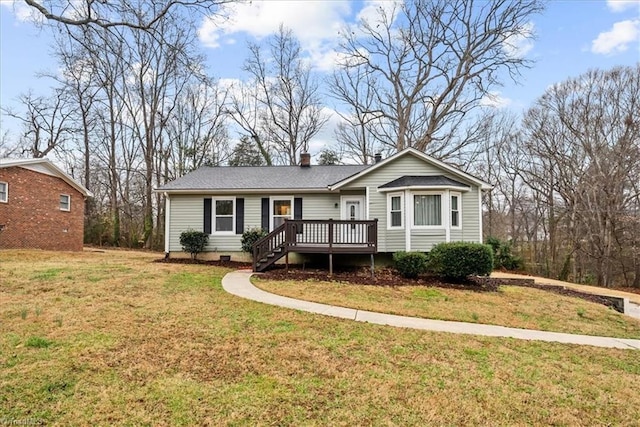 view of front facade featuring a wooden deck and a front yard