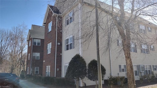 view of side of property with brick siding