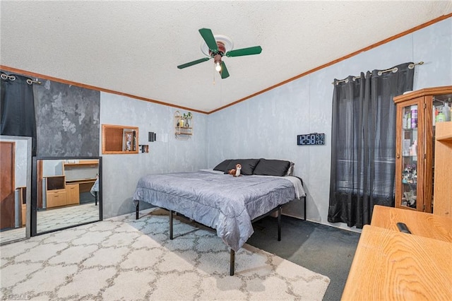 bedroom featuring ceiling fan, ornamental molding, carpet flooring, and a textured ceiling