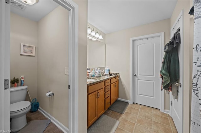 full bath with toilet, vanity, and baseboards