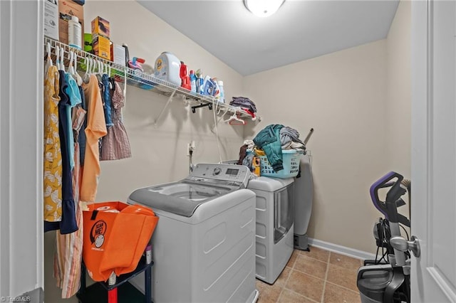 laundry room featuring separate washer and dryer and baseboards
