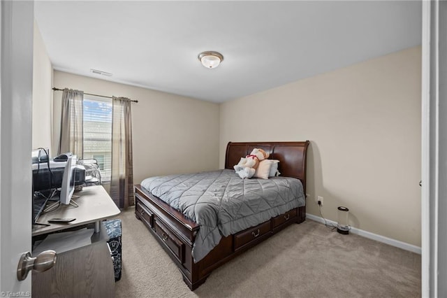 bedroom with light carpet and baseboards