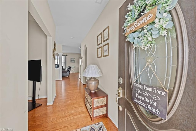 entrance foyer featuring wood finished floors and baseboards