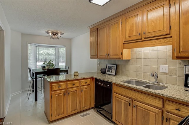 1935 Eastchester Dr Unit B, High Point, NC 27265 - kitchen with dishwasher, a sink, a peninsula, decorative backsplash, and light stone counters