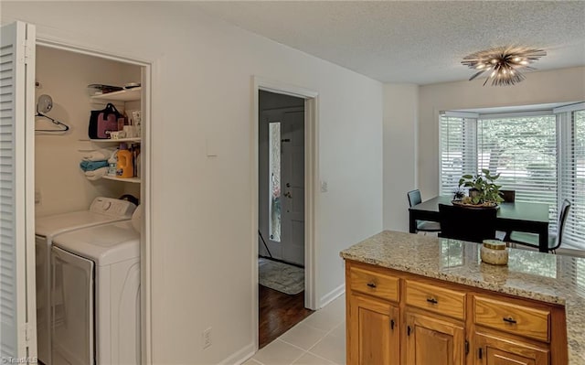 1935 Eastchester Dr Unit B, High Point, NC 27265 - laundry area featuring light tile patterned floors, washing machine and clothes dryer, and a textured ceiling