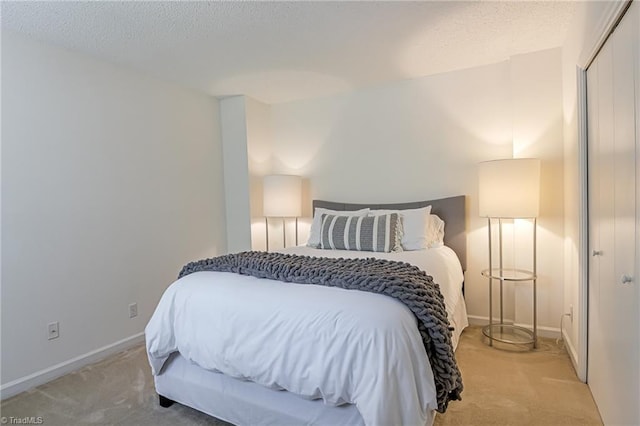 1935 Eastchester Dr Unit B, High Point, NC 27265 - bedroom featuring light colored carpet, a textured ceiling, a closet, and baseboards