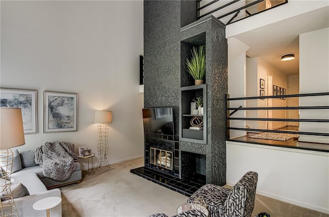 1935 Eastchester Dr Unit B, High Point, NC 27265 - living room with a high ceiling, carpet floors, baseboards, and a fireplace