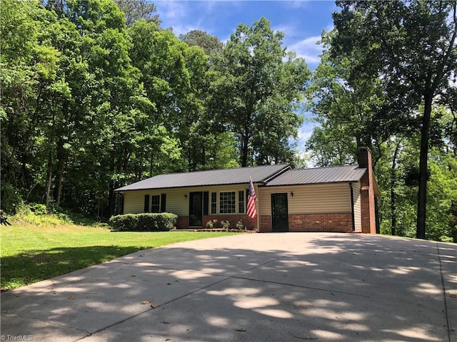 3960 Wards Gap, Cana, VA 24317 - view of front of property with driveway, a front yard, a chimney, metal roof, and brick siding