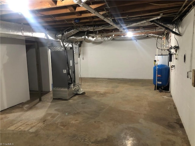 3960 Wards Gap, Cana, VA 24317 - unfinished basement with heating unit, a water pressure tank, and water heater