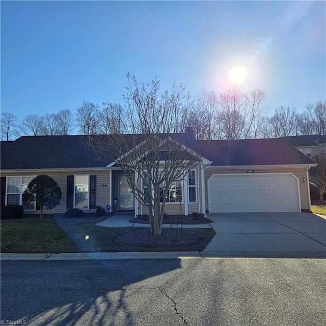 single story home with driveway and an attached garage