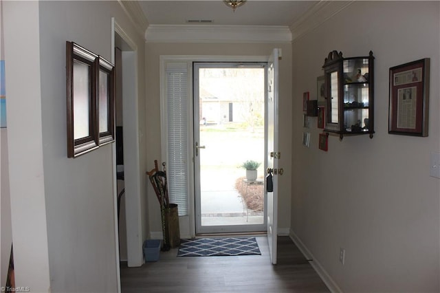 entryway featuring ornamental molding, visible vents, baseboards, and wood finished floors