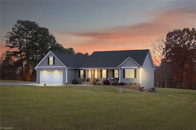 view of front of property with a lawn and a garage