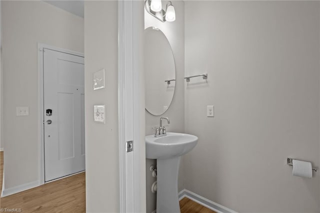 bathroom with hardwood / wood-style floors and sink