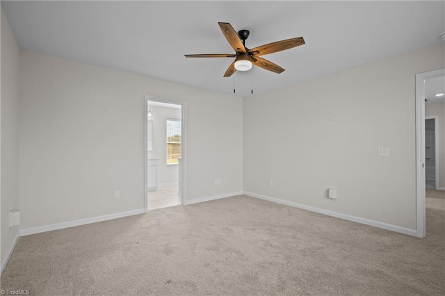 empty room with ceiling fan and light colored carpet