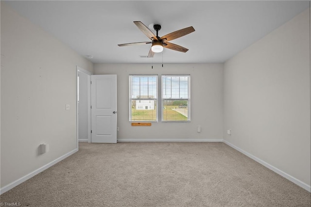 empty room with ceiling fan and light colored carpet