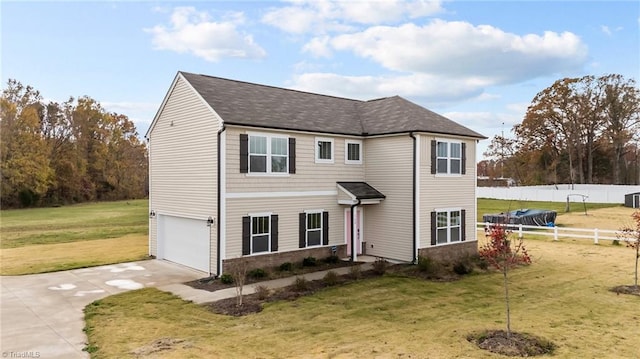 view of front of property featuring a front lawn and a garage