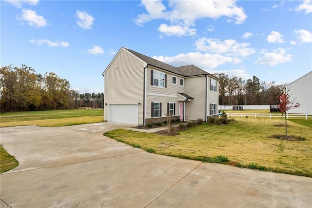 view of front of home with a front lawn and a garage